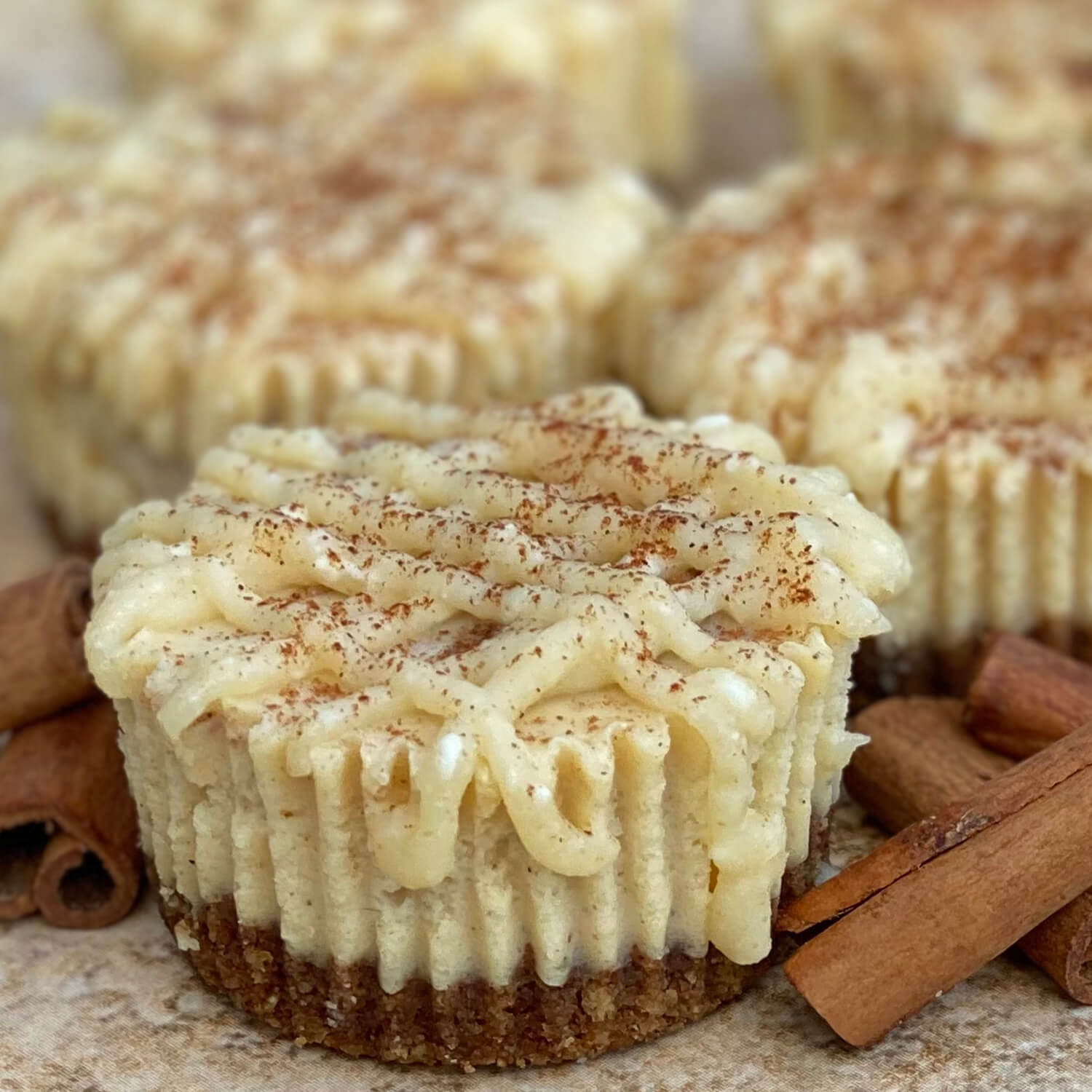 Brown Butter Cinnamon Roll - This yummy treat is a cheesecake version of a cinnamon roll that is elevated by the addition of brown butter. It starts with a cinnamon graham cracker crust. The creamy cheesecake has cinnamon brown butter swirled into it. It is topped with cream cheese brown butter icing and a sprinkle of cinnamon. This is one that you could even eat for breakfast.