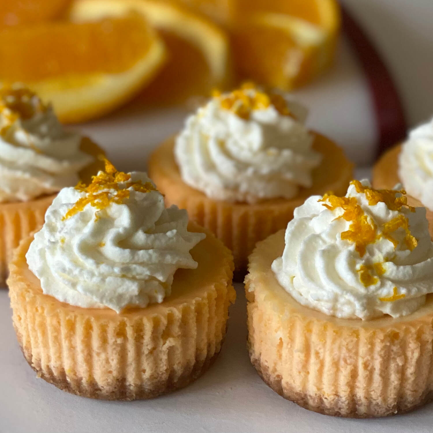Orange Creamsicle Orange Creamsicle - Step into summer with our June Flavor of the Month, Orange Creamsicle. Orange creamsicles are a refreshing frozen treat. The juicy orange flavor on the outside is complemented by the creamy middle. We have turned these flavors into a delicious summer cheesecake. It starts with a graham cracker crust. The orange cheesecake is swirled with creamy vanilla to make the perfect combination. It is topped with orange whipped cream and orange zest.