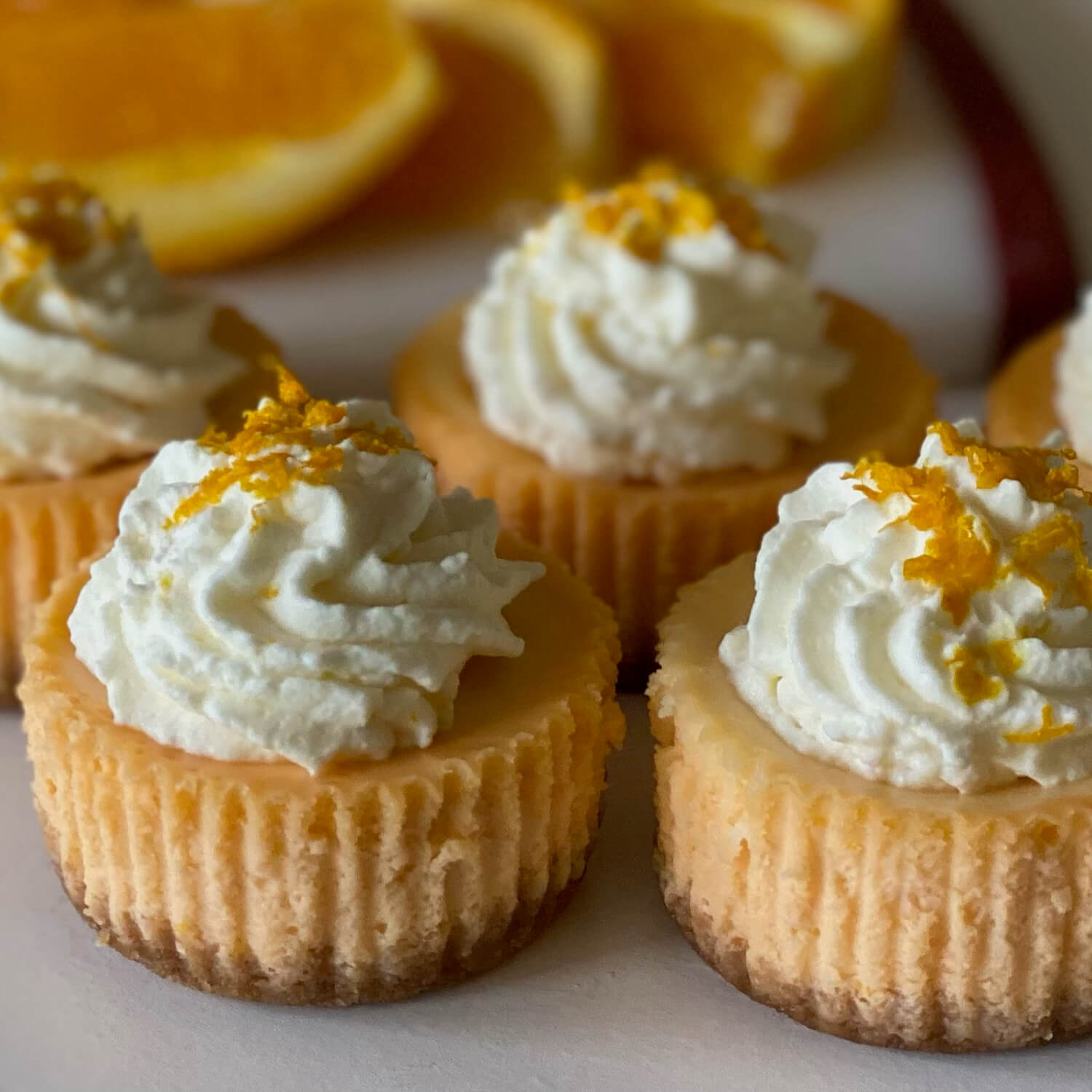 Orange Creamsicle Orange Creamsicle - Step into summer with our June Flavor of the Month, Orange Creamsicle. Orange creamsicles are a refreshing frozen treat. The juicy orange flavor on the outside is complemented by the creamy middle. We have turned these flavors into a delicious summer cheesecake. It starts with a graham cracker crust. The orange cheesecake is swirled with creamy vanilla to make the perfect combination. It is topped with orange whipped cream and orange zest.